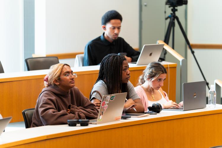 Audience members listen to N. Jeremi Duru as he speaks