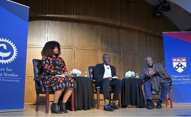 Charisse Burden-Stelly, Tukufu Zuberi, and Molefi Asante sit together during a debate.