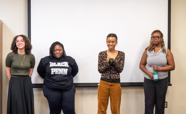 Africana Studies Major Seniors standing in front of white projection screen.