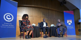 Charisse Burden-Stelly, Tukufu Zuberi, and Molefi Asante sit together during a debate.