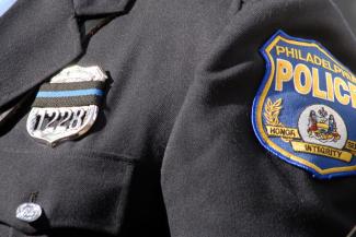 Close-up on a Philadelphia police badge on the shoulder of a uniform. Photo credit: WILLIAM THOMAS CANE / GETTY IMAGES