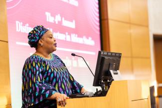 Madam Leymah Gbowee speaking from a podium