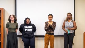 Africana Studies Major Seniors standing in front of white projection screen.