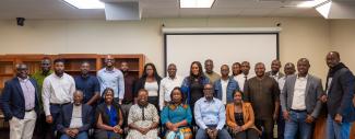 CFAS Director Wale Adebanwi (leftmost), UGhana Head of International Partnerships Nadia Kokui Torsu (front, third from left), and Africana Studies Librarian Mercy K. Ayilo sit amongst master's students from UGhana School of Law
