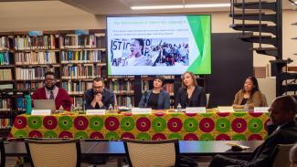 The panelists listen intently to an audience question.